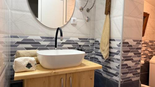 a bathroom with a sink and a mirror at Vikendica Cerović in Kraljevo