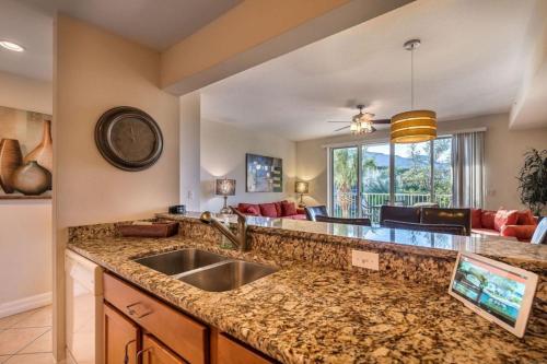 a kitchen with a sink and a living room at Bahia Beach Townhome in Ruskin