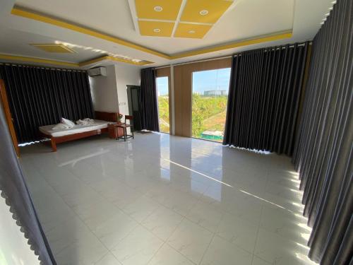a large room with a large window and a large tile floor at Happy Garden Hồ Tràm in Ho Tram