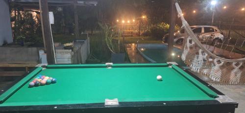 a pool table with balls on it in a backyard at Espaço Sairé - 8 minutos da Praia in Alter do Chao