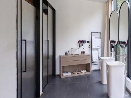 a bathroom with a toilet and a sink and a mirror at Jianglu Yalugu Hotel in Kaixuan