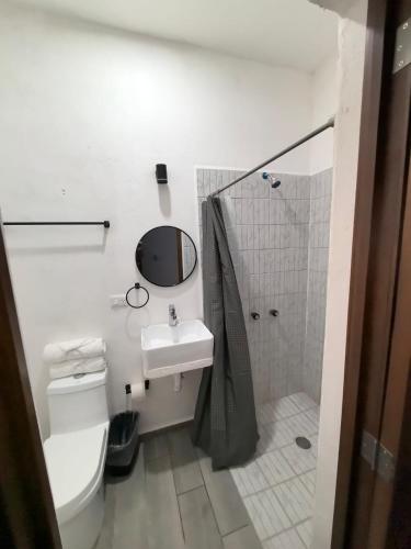 a bathroom with a toilet and a sink and a shower at Hotel Boutique Luz de Luna in San Blas