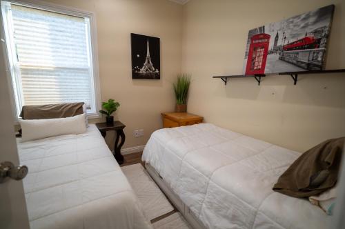 a bedroom with two white beds and a window at BV Guest House With Pool And Spa in Rancho Cucamonga