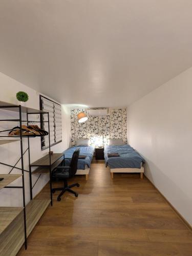 a bedroom with two beds and a loft at Luxury studio Évry - Ris, 25 min to Paris in Ris-Orangis