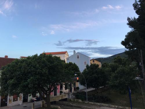 a group of buildings and trees on a street at Hotel Televrin in Nerezine