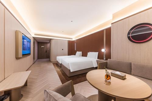 a hotel room with a bed and a couch at Crystal Hotel Guangzhou Huadu in Huadu