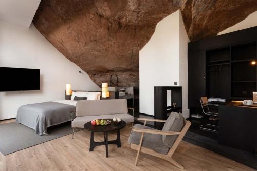 a bedroom with a bed and a couch and a table at Jianglu Yalugu Hotel in Kaixuan