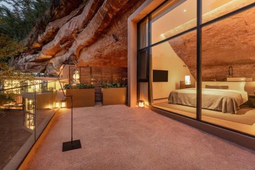a bedroom with a bed and a large window at Jianglu Yalugu Hotel in Kaixuan