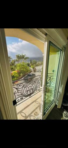an open door to a balcony with a view at BV Guest House With Pool And Spa in Rancho Cucamonga