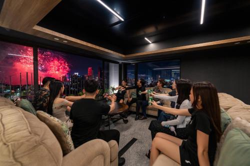 a group of people sitting in a room with drinks at Rest Hotel & Apartment in Da Nang