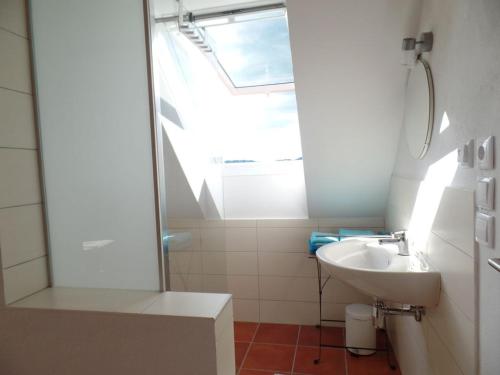 a white bathroom with a sink and a window at Holiday home with 2 bedrooms in Zgornja Kungota