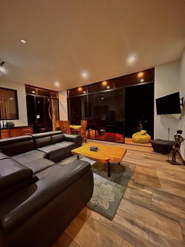 a living room with a couch and a table at Casa Fénix Zen Oasis Del Bosque in Calima