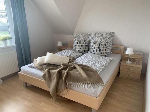 a bedroom with a bed with a blanket on it at Holiday apartment with 3 bedrooms in Hasselberg