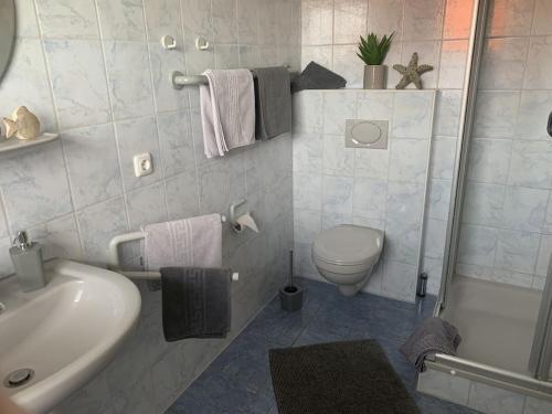 a white bathroom with a toilet and a sink at 1-bedroom holiday apartment in Hasselberg