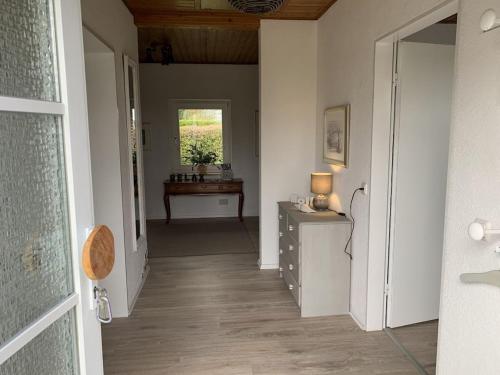a hallway with a desk and a table in a room at Holiday home in Karby with swimming pool in Karby