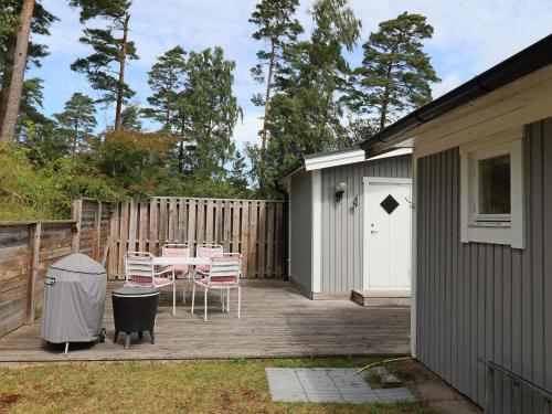 a patio with a table and chairs next to a building at 4 star holiday home in MELLBYSTRAND in Mellbystrand