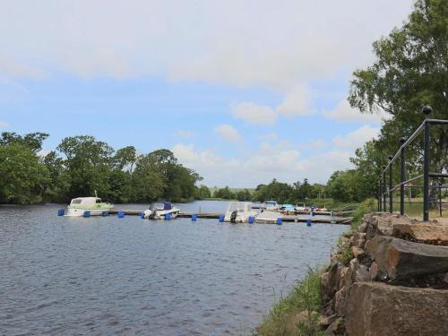 a group of boats are docked on a river at 4 star holiday home in MELLBYSTRAND in Mellbystrand