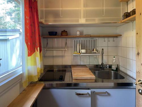 a small kitchen with a sink and a window at 4 star holiday home in DEGEBERGA in Degeberga