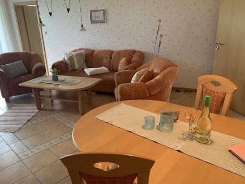 a living room with a table and chairs and a couch at Holiday apartment with 2 bedrooms in Hasselberg