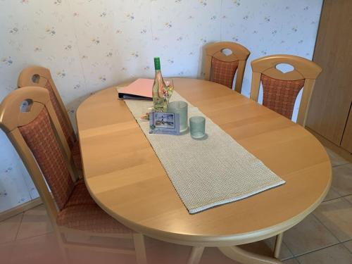a wooden table with chairs around it with a napkin at Holiday apartment with 2 bedrooms in Hasselberg