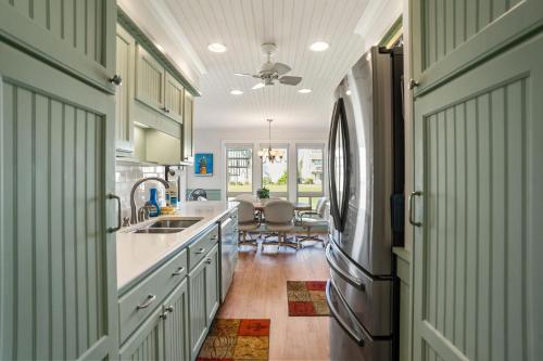 a kitchen with a sink and a refrigerator at 133 Captain John Fripp - 3 BD/2 BA with Resort Amenities! in Fripp Island