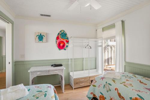 a bedroom with a bed and a mirror at 133 Captain John Fripp - 3 BD/2 BA with Resort Amenities! in Fripp Island