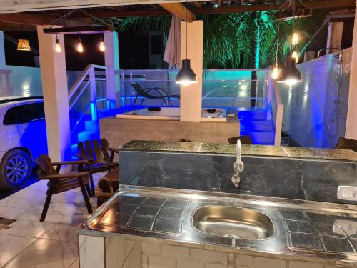 a kitchen with a sink and a view of a car at Refugio dos Carneiros in Praia dos Carneiros