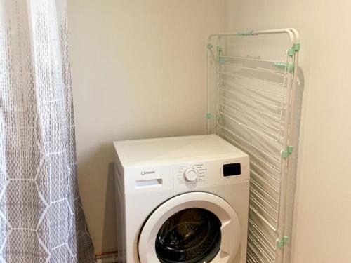 a washer and dryer in a corner of a room at La Grange: Gîte Confort à Briou, 5 Chambres - FR-1-491-471 