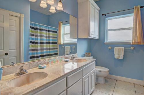 a bathroom with two sinks and a toilet at Casa Las Palmas - Pet Friendly! Boardwalk to the Beach! in Mustang Beach