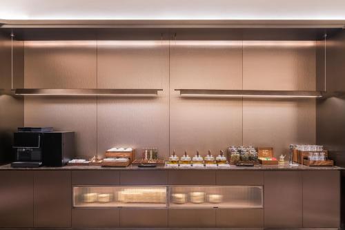a kitchen with a counter with food on it at Crystal Hotel Guangzhou Huadu in Huadu
