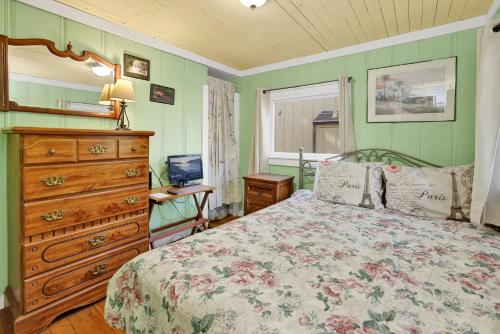 a bedroom with a bed and a dresser and a window at Pines 23 #1438 in Big Bear Lake