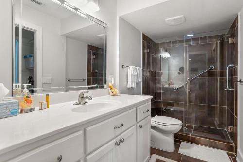 a bathroom with a sink and a toilet and a shower at 133 Captain John Fripp - 3 BD/2 BA with Resort Amenities! in Fripp Island