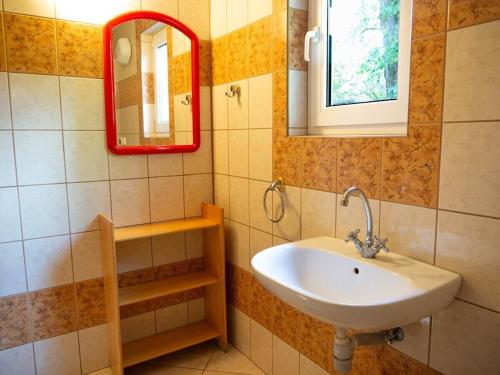 a bathroom with a sink and a mirror at at the lake with a boat in Spychowo