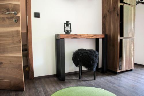 a table in a room with a green rug at Guesthouse S in Luče