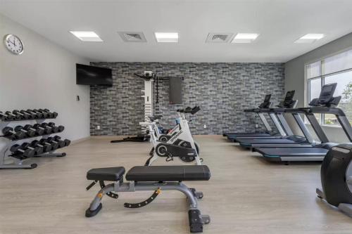 a gym with treadmills and elliptical machines at DoubleTree by Hilton Greenville Woodruff Road in Greenville