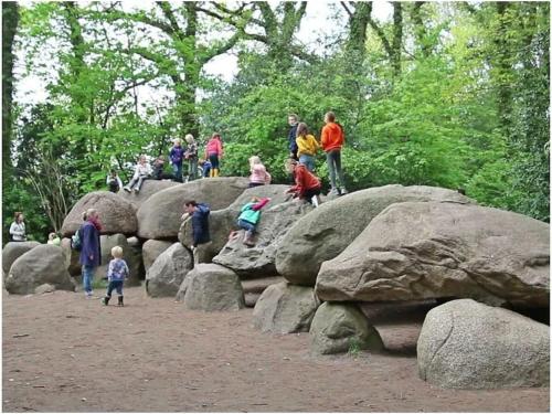 a group of people standing on some rocks at Holiday home with 2 bedrooms in Zwiggelte