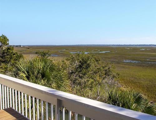 a balcony with a view of a field with plants at Sea Palms Resort St Simons Island in Saint Simons Island