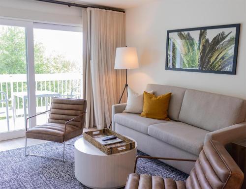 a living room with a couch and a chair at Sea Palms Resort St Simons Island in Saint Simons Island