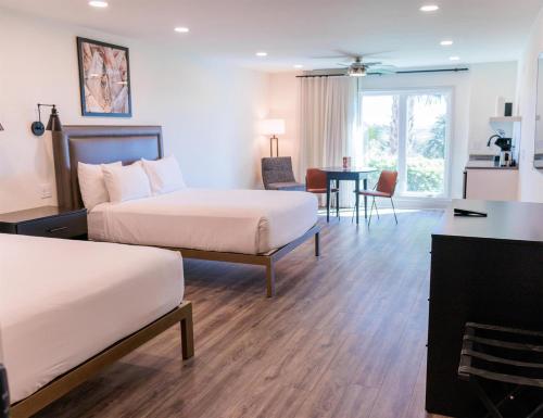 a hotel room with two beds and a table at Sea Palms Resort St Simons Island in Saint Simons Island