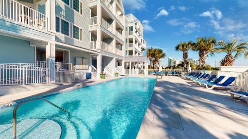 a swimming pool in front of a building at Cozy 2BD/2BA w/ View, Sleeps 6 in Orange Beach