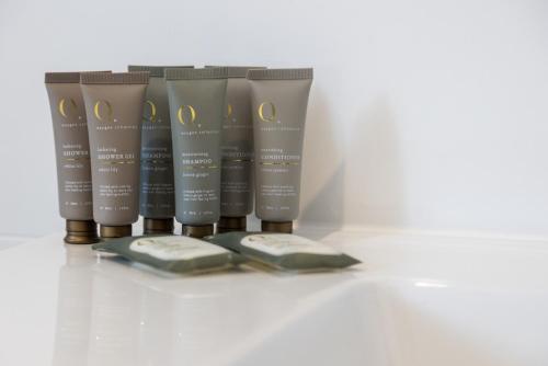 a group of four products sitting on a white counter at Bright 2-Bed Apartment Steps from Largs Bay Beach in Largs