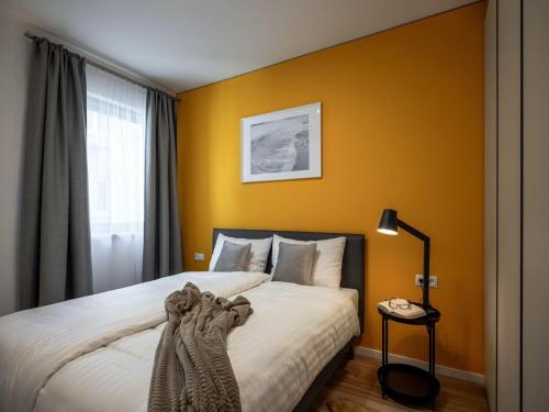 a bedroom with yellow walls and a bed at Family apartment in Schwaz in Schwaz