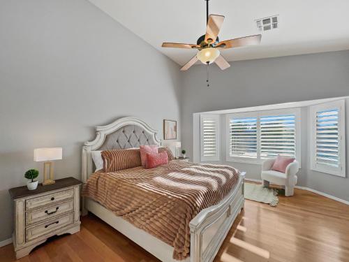 a bedroom with a bed and a ceiling fan at Kimberly Surprise in Surprise
