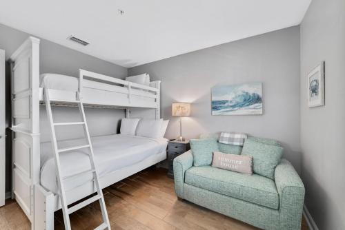a bedroom with a bunk bed and a chair at Cozy 2BD/2BA w/ View, Sleeps 6 in Orange Beach