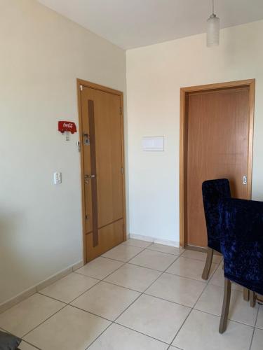 a room with two doors and a table and chairs at Bela vista in Taubaté