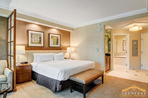 a hotel room with a bed and a chair at MGM Signature-03-611 Strip View Jacuzzi Studio in Las Vegas