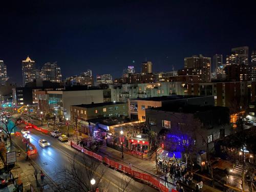 a view of a city at night with lights at Quiet City Retreat, Modern Comfort in the Heart of Calgary in Calgary