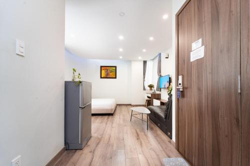 a living room with a refrigerator and a bedroom at Jade house Nguyễn Thị Minh Khai in Ho Chi Minh City