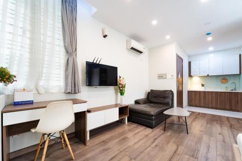 a living room with a desk and a chair at Jade house Nguyễn Thị Minh Khai in Ho Chi Minh City