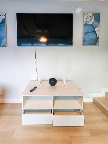 a white coffee table in a living room with a tv at Relaxing Cozy Back House with Backyard in Upland